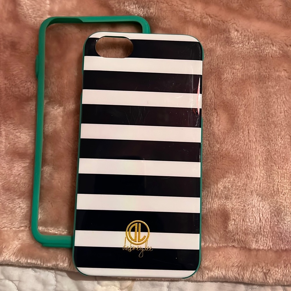 IPhone 7 Plus case teal in color with rubber piece.
